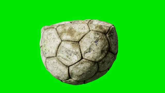 old deflated soccer ball on green chromakey background