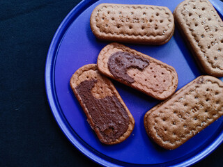 Chocolate filled biscuit on a purple plate
