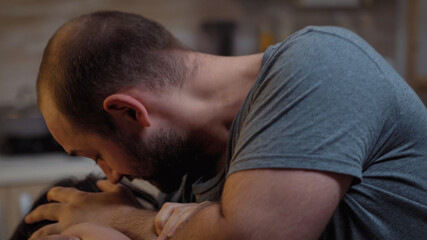 Brutal man raising hand to his wife screaming and fighting. Abused terrified beaten woman covered...