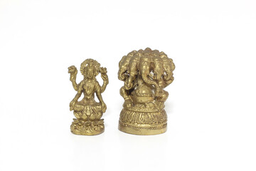 Brass figure of the Hindu goddess Lakshmi and Ganesha on white background.