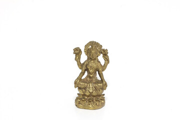 Brass figure of the Hindu goddess Lakshmi on white background.