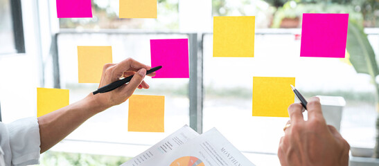 Business team working marketing growth on financial document graph report statistics, using post it notes in glass wall to writing strategy business plan to development grow to success