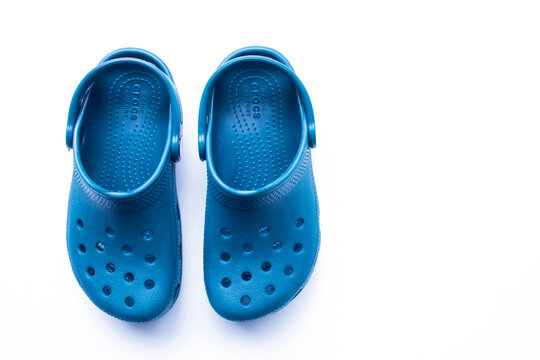 Calgary, Alberta, Canada. Nov. 19, 2020. Blue Crocs footwear, foam clog shoes on a white background.