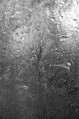 Vertical ice texture background. Frozen window on a winter night. 