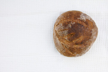 Homemade rye wheat sourdough bread with a crisp crust on a moneycomb towel background. Flat lay. Copy space