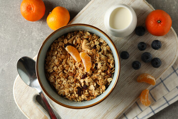 Concept of tasty breakfast with granola on gray background