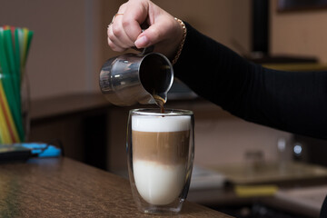 Barista girl pours coffee. Latte making process