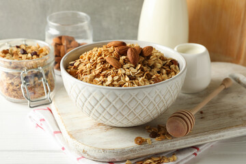 Concept of tasty breakfast with granola on white wooden background
