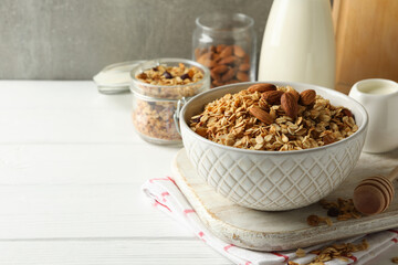 Concept of tasty breakfast with granola on white wooden background