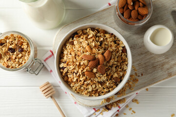 Concept of tasty breakfast with granola on white wooden background