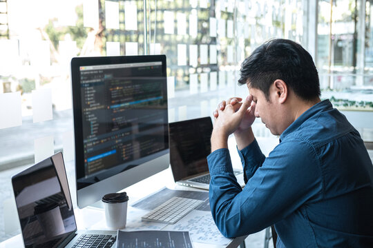 Stressed tired out of work, Development Programmer working in programming website a software and coding technology, writing codes and data code, Programming with HTML, PHP and javascript