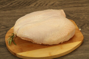 Raw whole chicken breast with skin