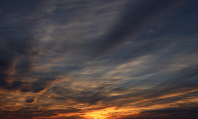 Dark blue sky with Golden rays of the setting sun on an autumn evening, autumn landscape