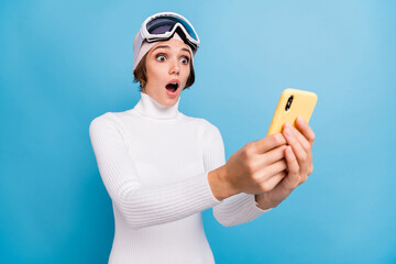 Photo of pretty brunette bob haired girl hold phone amazed blog wear white pullover isolated on...