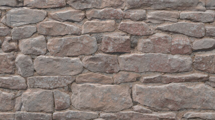 The uneven, cracked surface of a real stone wall is gray. Background of old dirty stones damaged by time. 3D-rendering