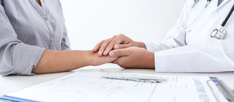 Image of doctor holding patient's hand to encourage, talking with patient cheering and support, healthcare and medical assistant