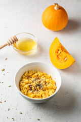 Ripe, fresh pumpkin and porridge from it, honey. Homemade food..healthy breakfast