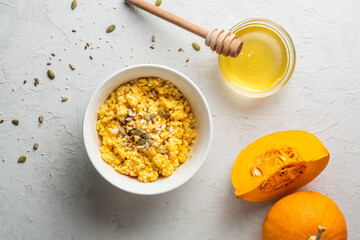 Ripe, fresh pumpkin and porridge from it, honey. Homemade food..healthy breakfast