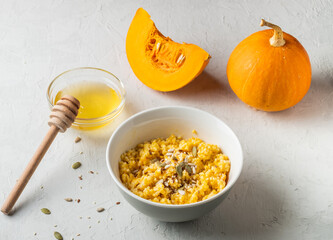 Ripe, fresh pumpkin and porridge from it, honey. Homemade food..healthy breakfast