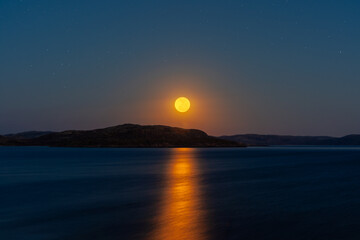Full moon over the sea Moon path on the calm water. Fantasy image 