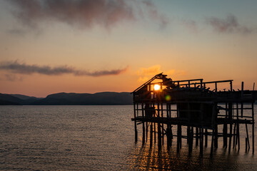 Obraz premium Old abandoned wooden fisherman building, sunrise at the pier on Barents Sea. Teriberka, Murmansk district. Kola Peninsula. Russian polar region. 