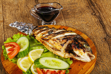 Grilled dorada fish with sauce