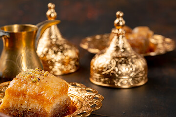 Piece of Turkish baklava in golden arabic plate