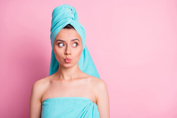 Portrait of sweet nice young lady blow kiss look empty space wear teal bath towels on head body isolated on pink color background