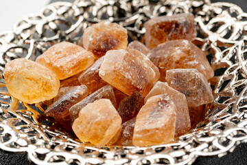 Silver plate with lumps of sugar on table