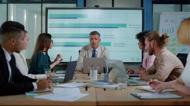 Manager and coworkers discussing financial strategy. Business team meeting.