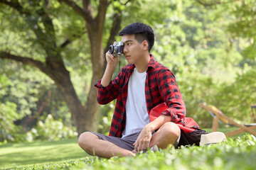 Happy Asian man backpacker in beautiful nature