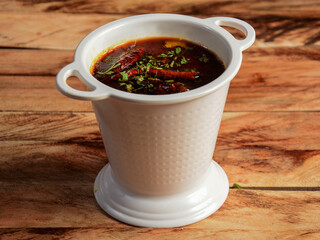 Authentic Indian popular food Dal Tadka Curry or Traditional Indian soup lentils on rustic wooden background. selective focus