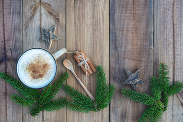 Vintage zero waste Christmas composition.  Christmas tree twigs, white latte cappuccino coffee, wooden spoon, cinnamon sticks and Xmas  stars on wooden background.  Top view, flat lay, copy space.