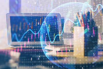 Double exposure of chart and financial info and work space with computer background. Concept of international online trading.