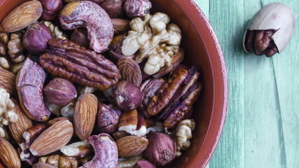 variety of nuts almonds hazelnuts cashews walnuts on a wooden background top view place under the...