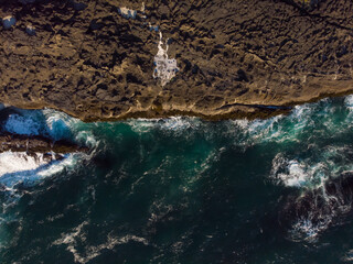 Aerial view of ocean waves and fantastic rocky coast. Discover the world concept. Natural landscape. Wallpaper design.