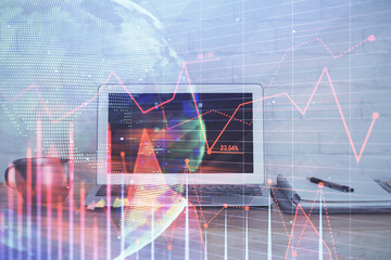 Stock market graph and table with computer background. Multi exposure. Concept of financial analysis.