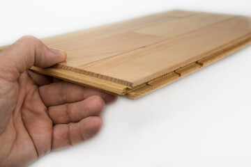 Wooden parquet floor with a click assembly on a white background