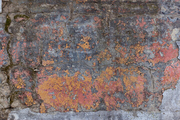Texture of old gray stone concrete wall with cracks with fragments of peeling paint