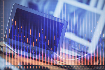 Financial chart drawing and table with computer on background. Double exposure. Concept of...
