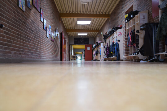 Empty School Hallway With Wood Floors