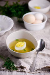 Chicken broth with boiled egg.style rustic