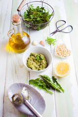 fresh wild herbs pesto ingredients on wooden table
