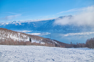 Winter landscape high in the mountains with blue sky and lake