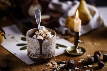Hot chocolate with whipped cream and toasted almonds in a ceramic glass