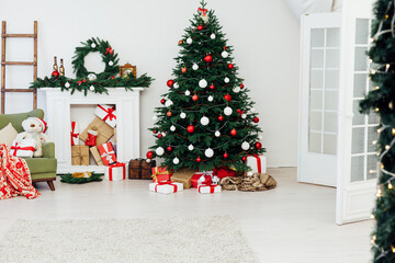 Fototapeta na wymiar Christmas interior of the christmas tree pine new year gifts