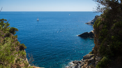 Scenic view on the blue Mediterranean sea horizon, with a sailboat, 