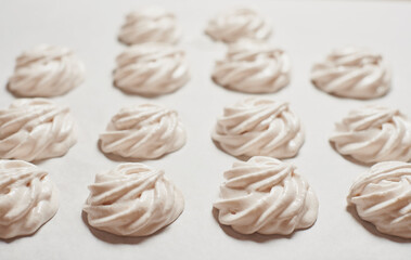 Cooked homemade sweet food a meringue cookies on baking paper