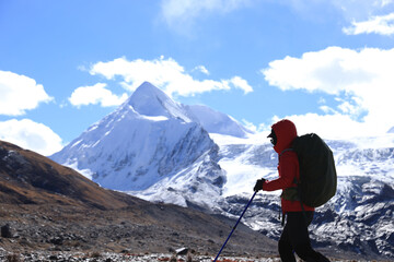 Woman hiker hiking  in winter mountains