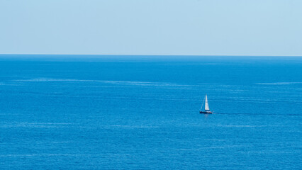 Fototapeta premium Boat sailing on the blue Mediterranean Sea, 